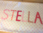 Preview: Namenskissen Stella Punkte weiß-rose 40x65